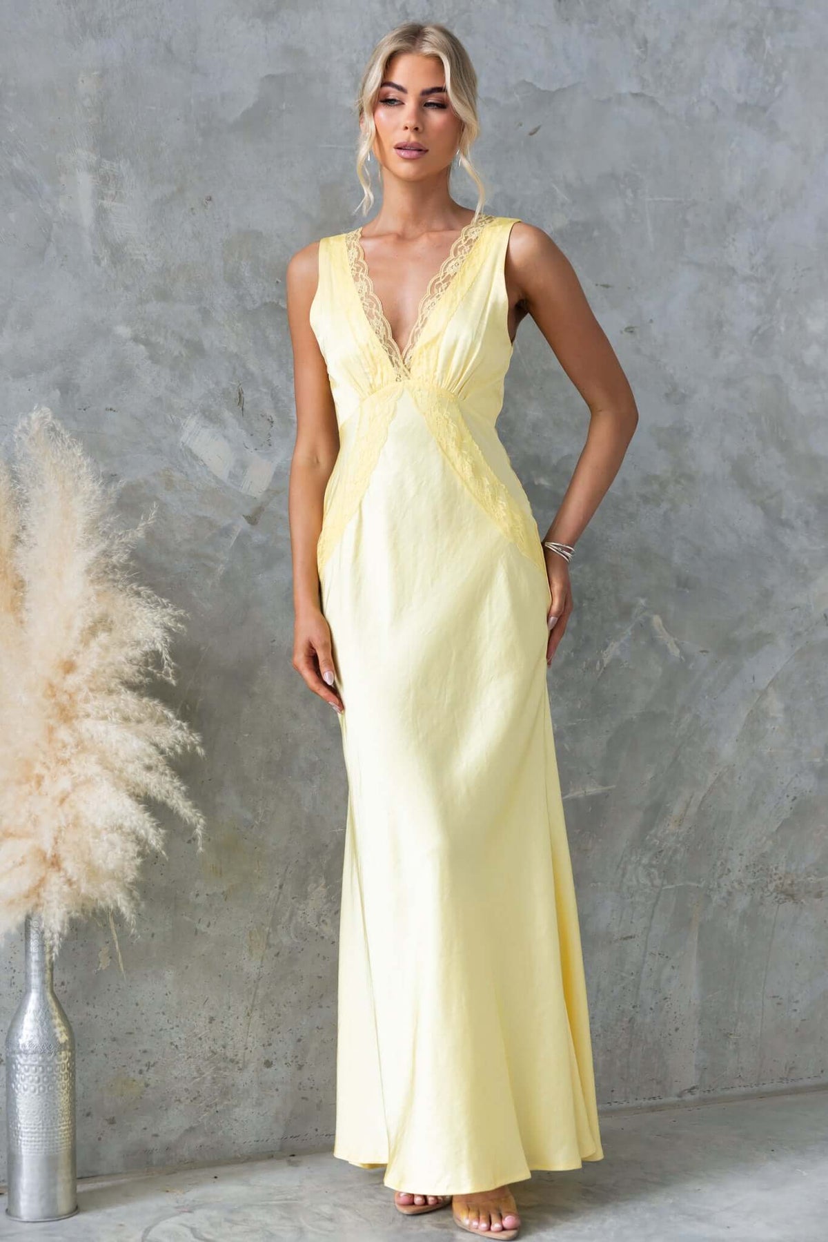 Uvira Maxi Dress featuring a V-neckline and lace trim, perfect for bridal or formal occasions in soft yellow.