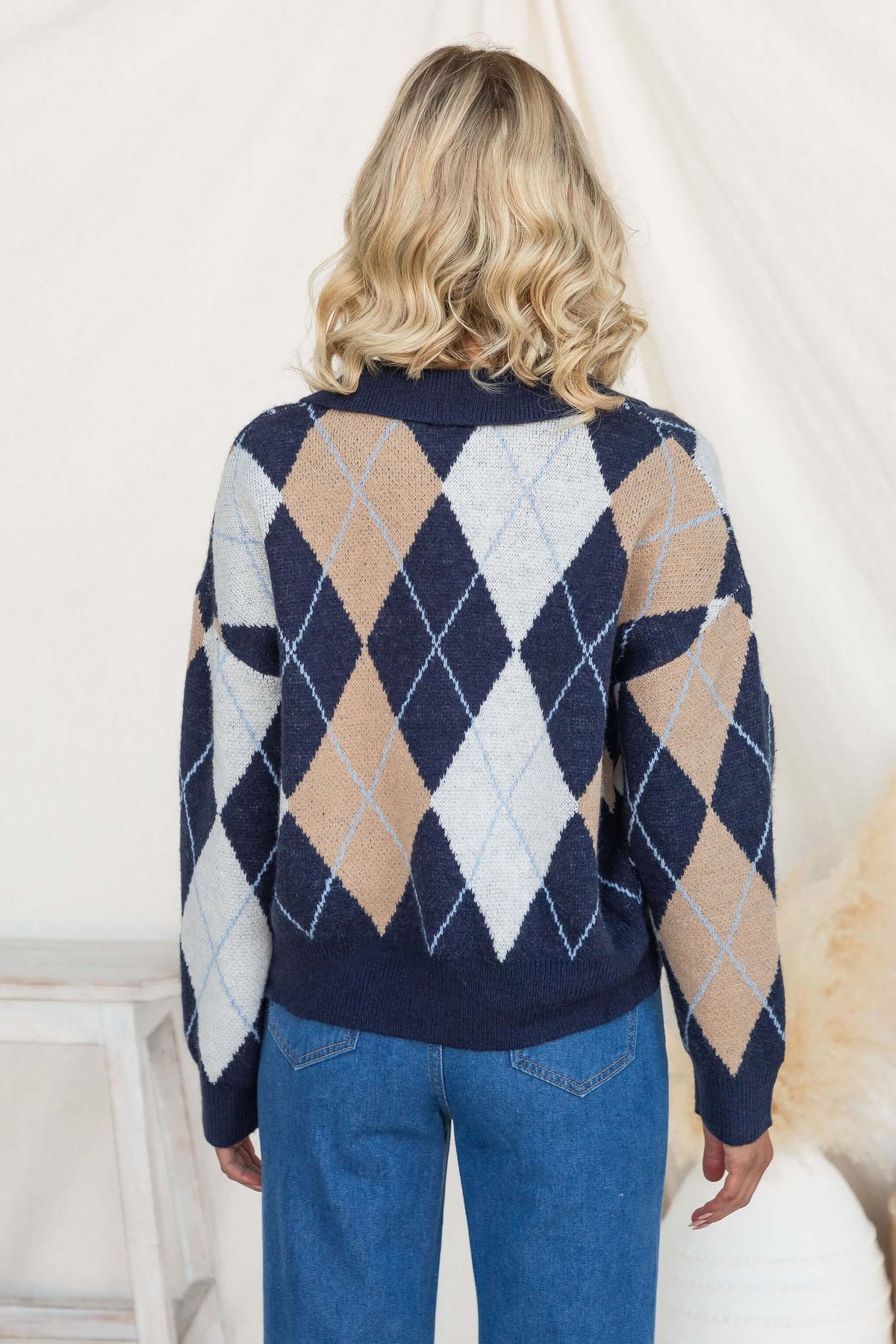 Back view of Vella Jumper featuring navy knit with diamond patterns and a stylish collar.