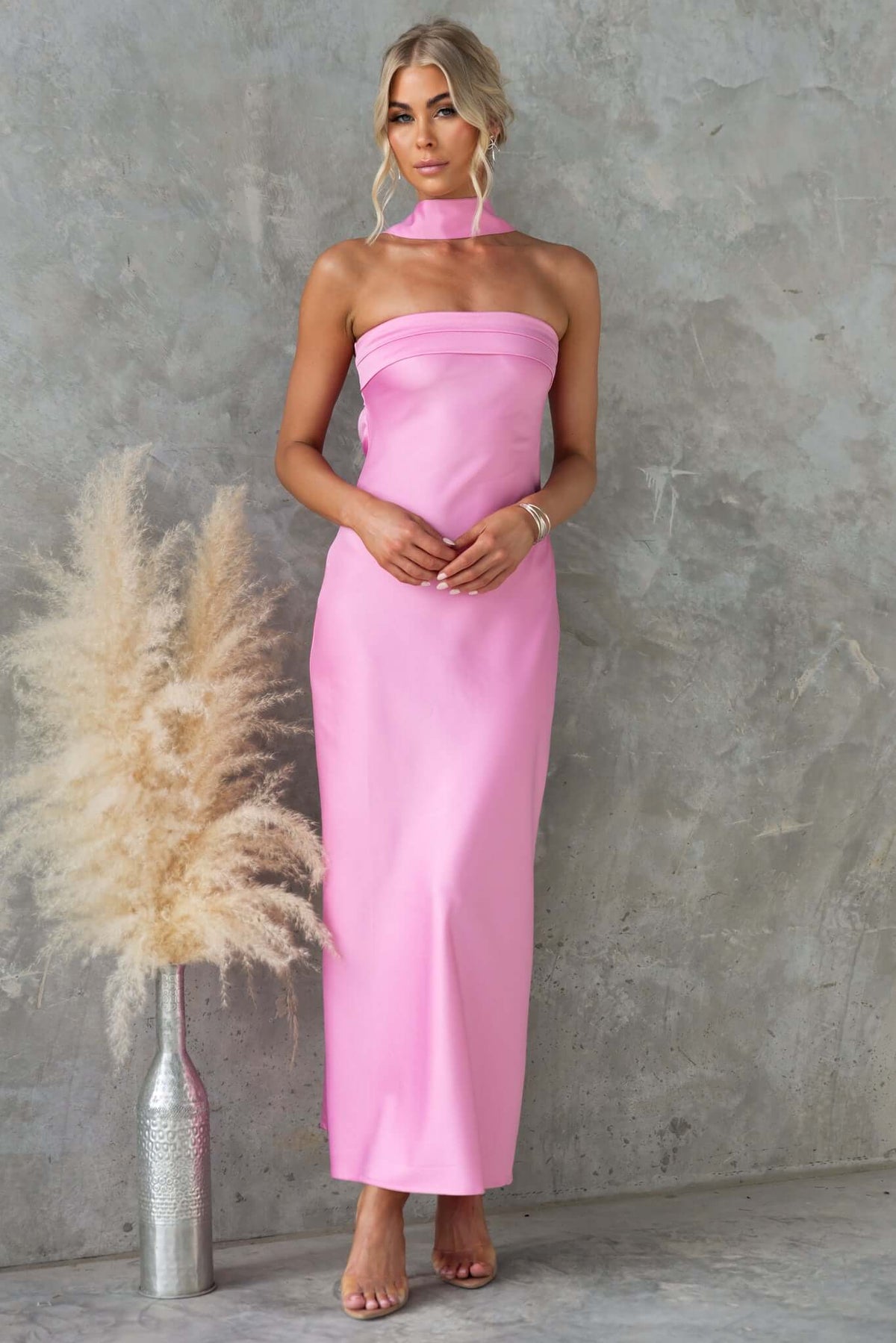 Verda Maxi Dress in pink, strapless design with removable tie, featured with a floral decoration.