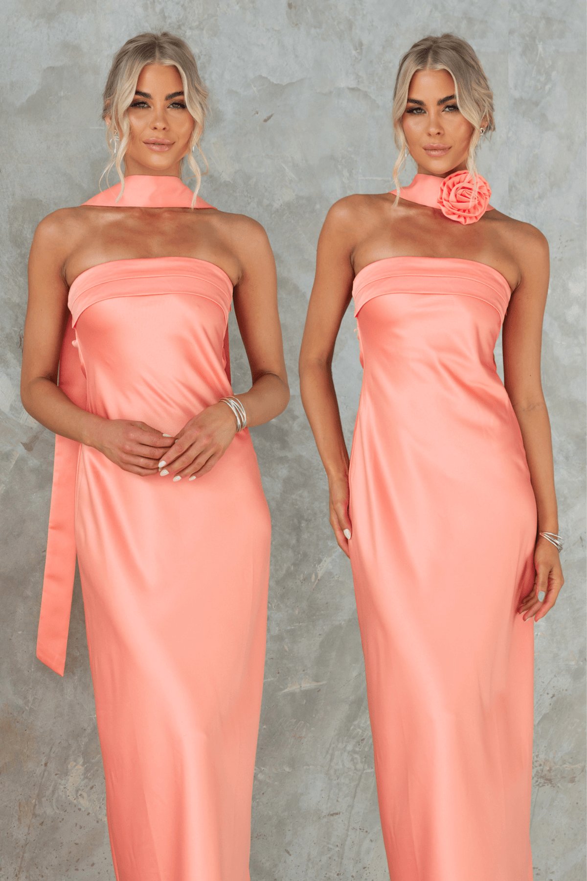 Two models wearing the Verda Maxi Dress in coral; strapless design with removable tie and broach.