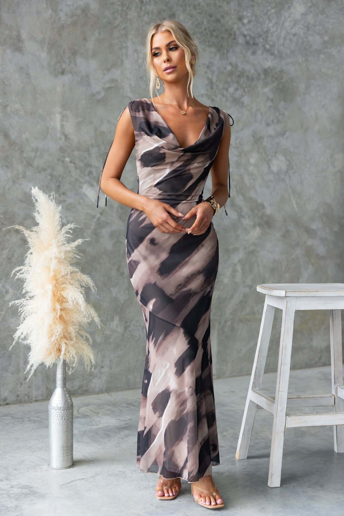Model wearing Verone Maxi Dress with cowl neckline and tie detail, showcasing stylish print and low-cut back.