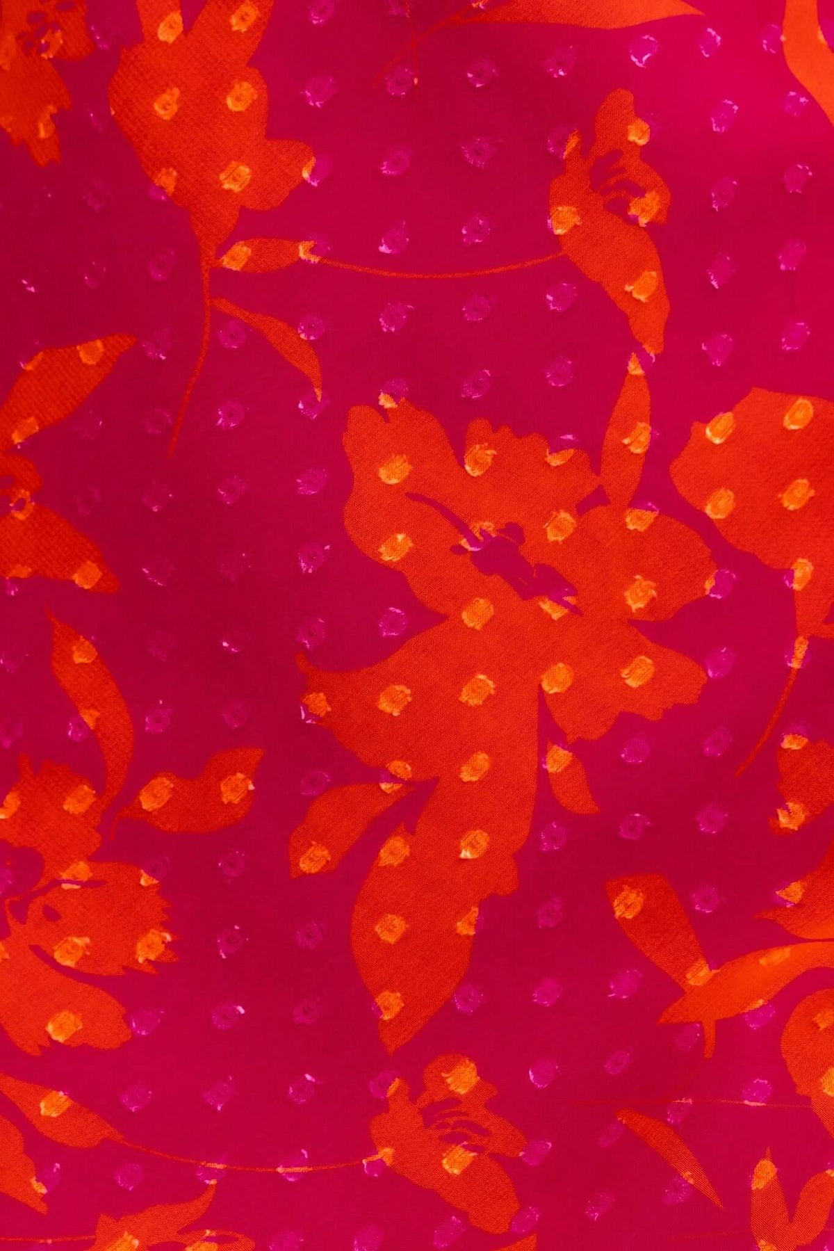 Vibrant pink fabric with orange floral patterns, featuring textured dots, perfect for a stylish summer maxi dress.