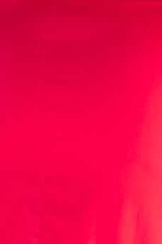 Close-up of vibrant red fabric, showcasing a smooth texture ideal for a stylish Vitoria Maxi Dress.