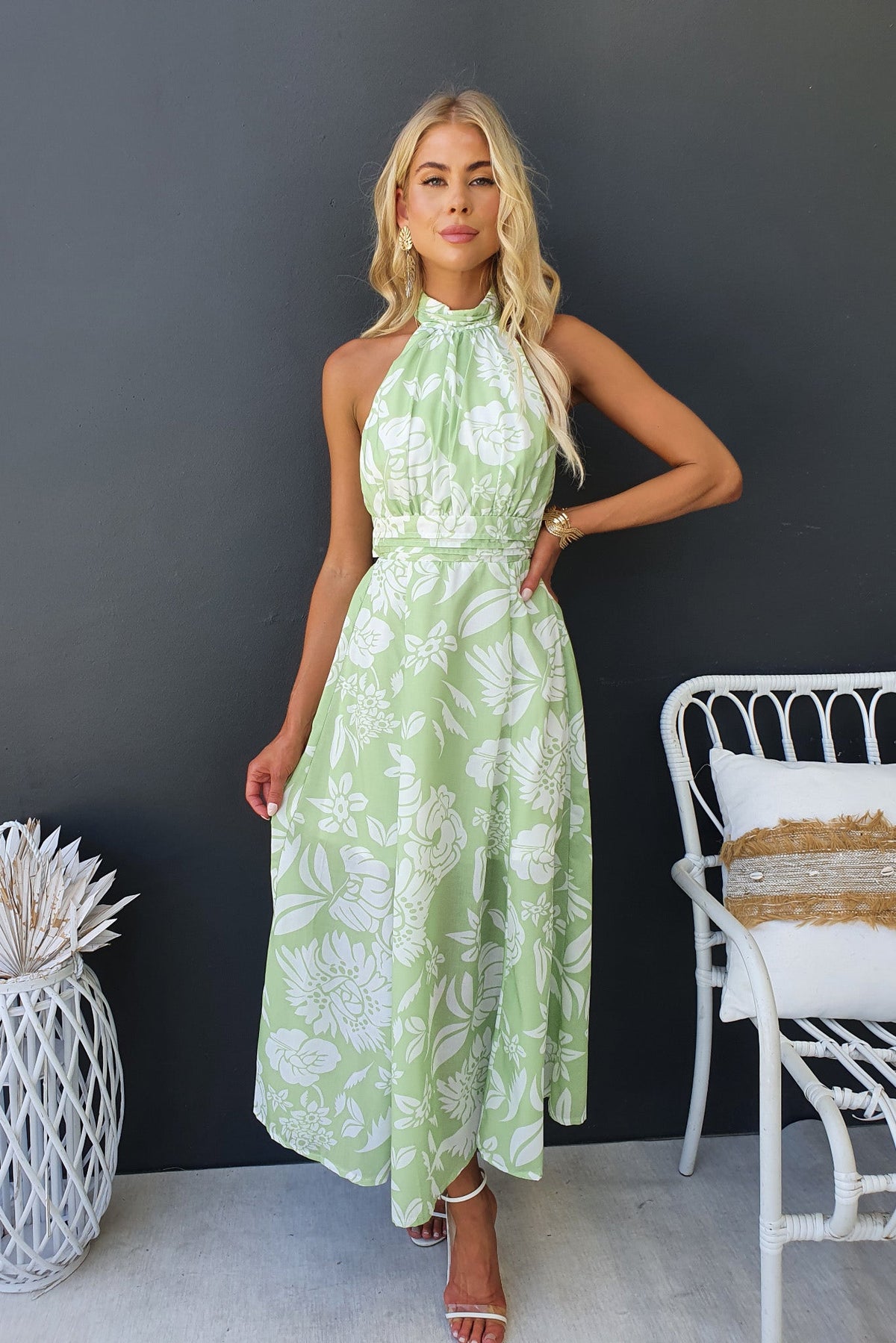 Floral print midi dress in green with adjustable halter neckline and tie back, showcasing a summer-ready look.