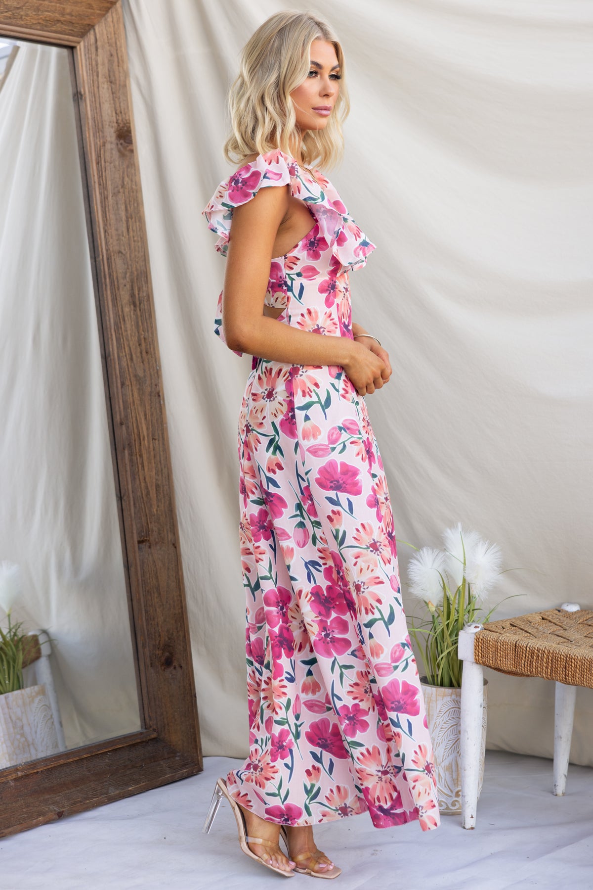 Wilma Maxi Dress with floral print, ruffle sleeves, and back tie, shown on model against a natural backdrop.