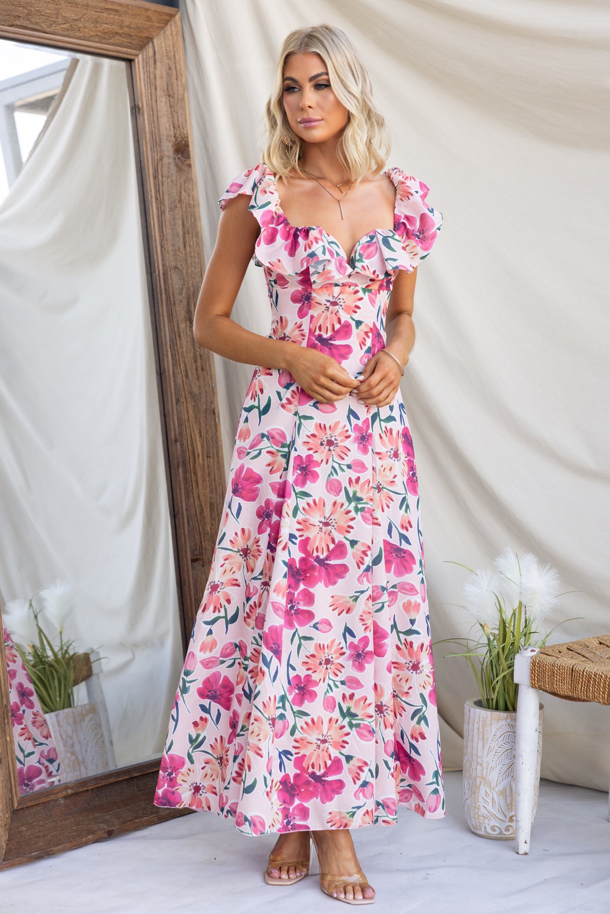 Wilma Maxi Dress featuring floral print, ruffled sleeves, and fitted bodice, ideal for summer occasions.