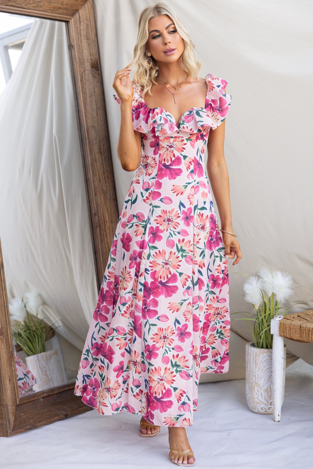 Wilma Maxi Dress featuring floral print, ruffled sleeves, and back tie detail, ideal for summer occasions.