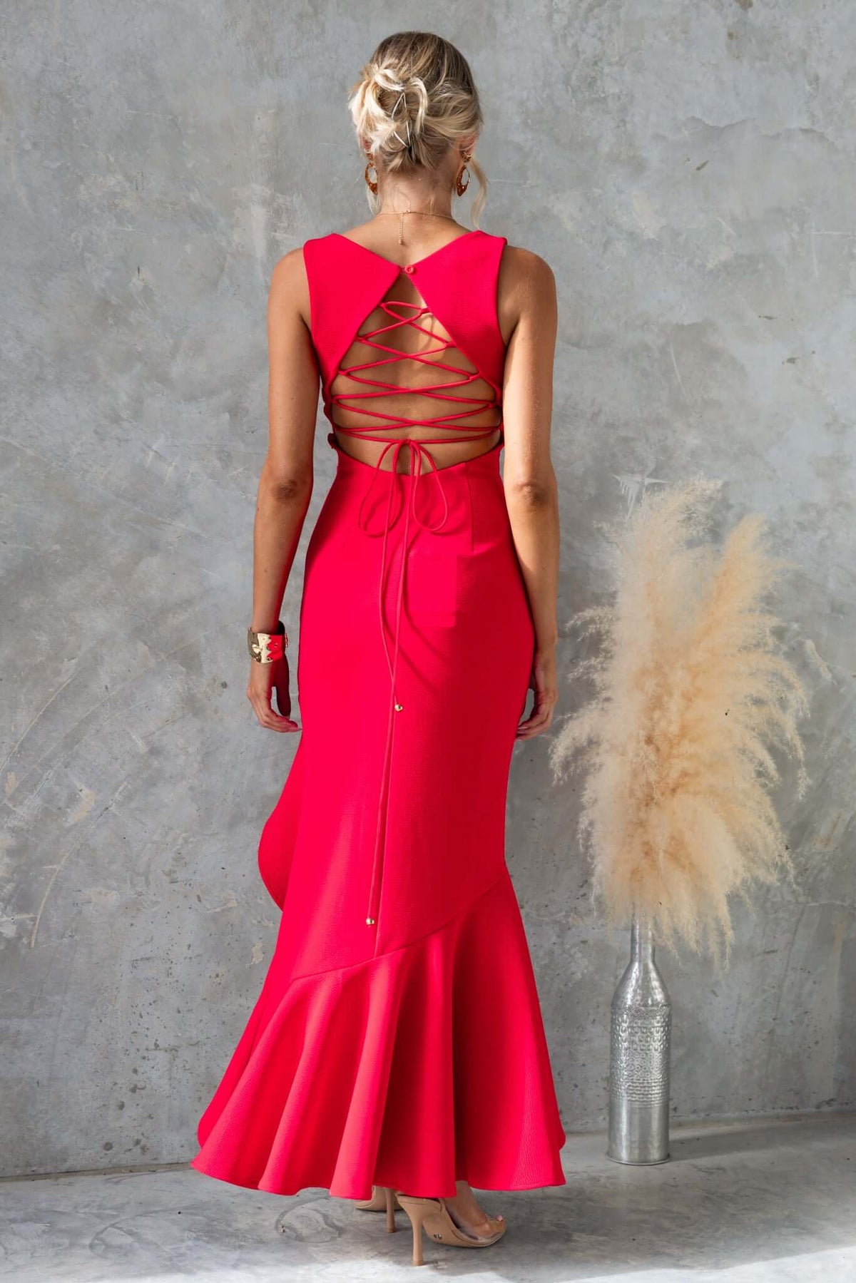 Stylish Wyetta Maxi Dress in bright pink with high neckline and crisscross lace-up back detail.