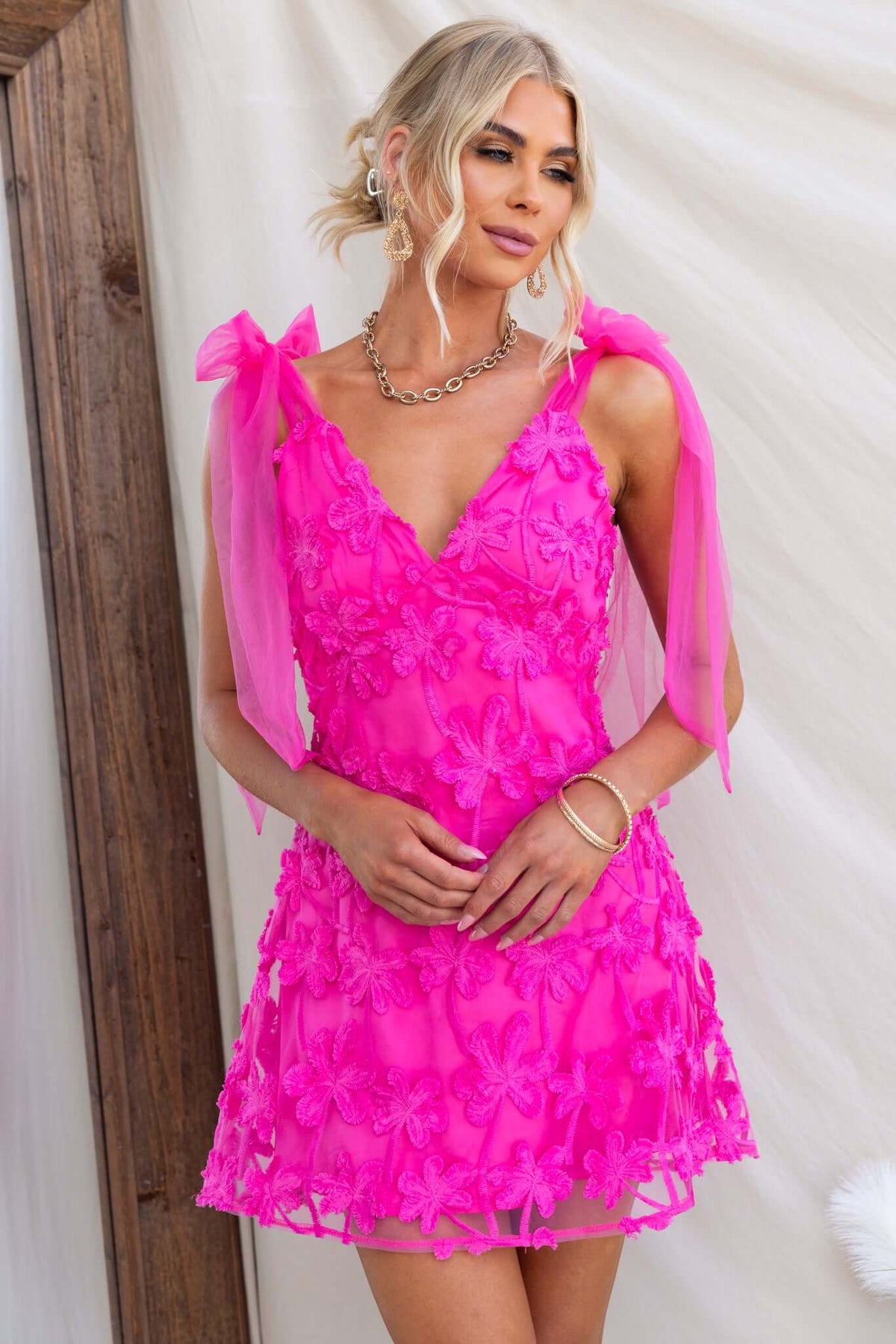 Xaria Dress in vibrant pink, featuring tie straps and embroidered tulle, perfect for special occasions.