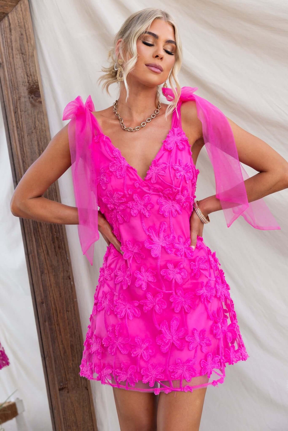 Xaria Dress with tie straps in vibrant pink tulle embroidered material, featuring a zip at the back and a lined, non-stretch fit.
