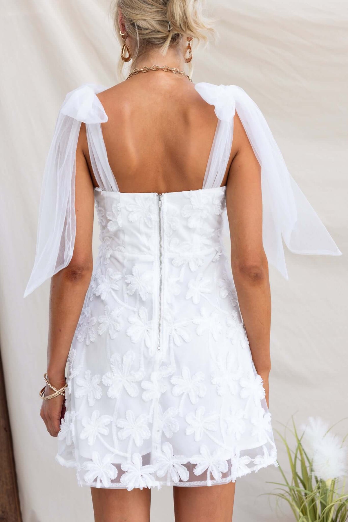 Back view of Xaria Dress featuring tie straps, tulle embroidery, and zipper closure in white.