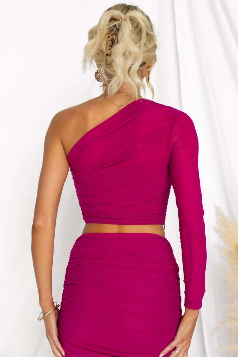 Back view of Xylah Top featuring a one-shoulder design in vibrant fuchsia with ruched detailing.